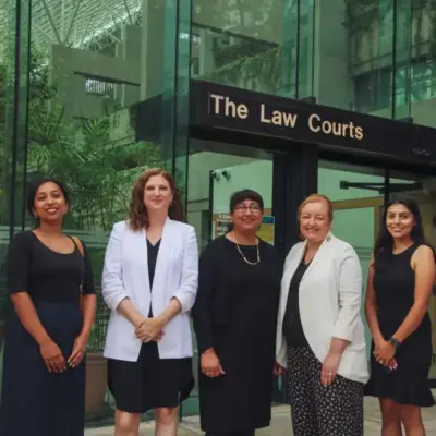 Five lawyers from West Coast LEAF and the Centre for Family Equity stand in front of the BC Law Courts.