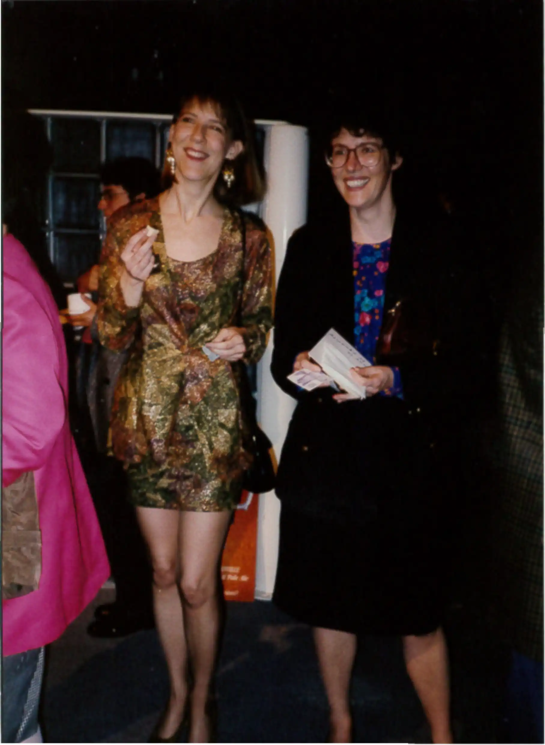 Two white woman are wearing semi-formal clothes and smiling candidly.