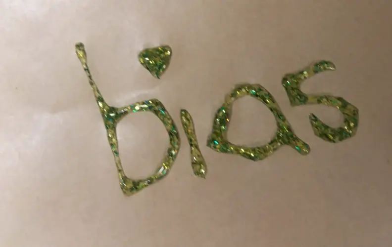 Green glitter reads "bias".