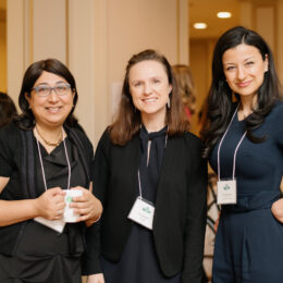 Three West Coast LEAF employees are wearing name tags and smiling at the camera.