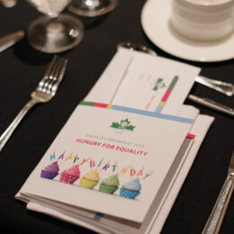 A place setting at the Breakfast, including an event program celebrating 35 years with cupcakes on the cover.