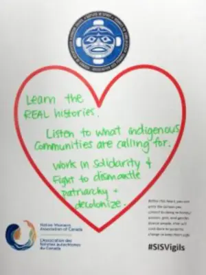 Image of white piece of paper with red heart and writing in the middle that reads “Learn the REAL histories. Listen to what Indigenous communities are calling for. Work in solidarity and fight to dismantle patriarchy and decolonize.”
