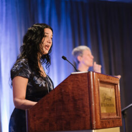 West Coast LEAF executive director Kasari Govender is speaking behind a podium.