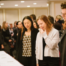 People walk by displays for the silent auction.