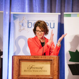 Emcee Gloria Macarenko introduces the speakers.