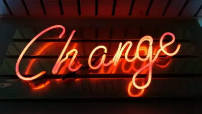 An orange and red neon sign that says "Change".