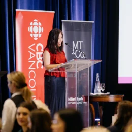 Emcee Michelle Eliot begins the Equality Breakfast by greeting attendees from the stage.