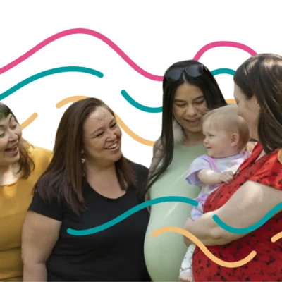 group of four people surrounding a baby. Everyone is smiling at the baby. Swirls of colorful lines surround them.